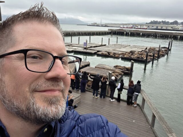 Jason Payne taking a selfie with the sea lions at PIER 39.